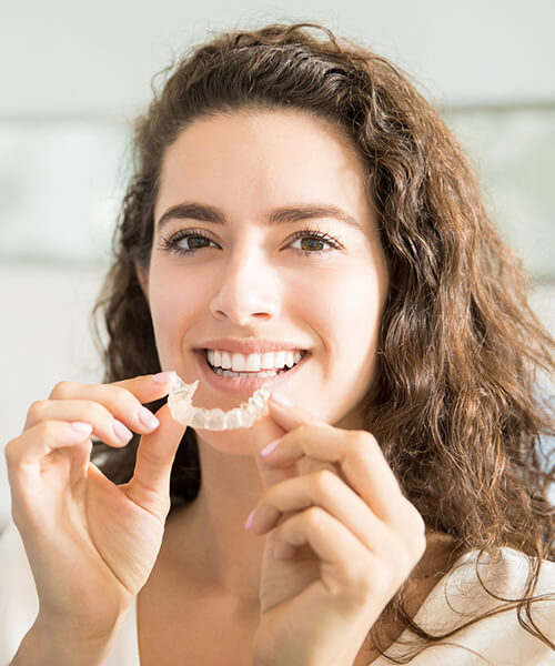 Young woman holding invisalign