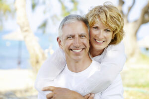 A middle-aged couple embrace and smile