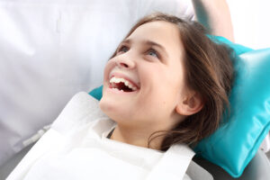 Girl-is-smiling-in-dental-chair
